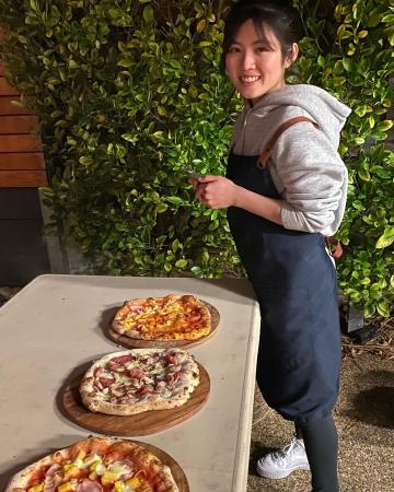 Ashley stretching and cooking her first wood fired pizzas!